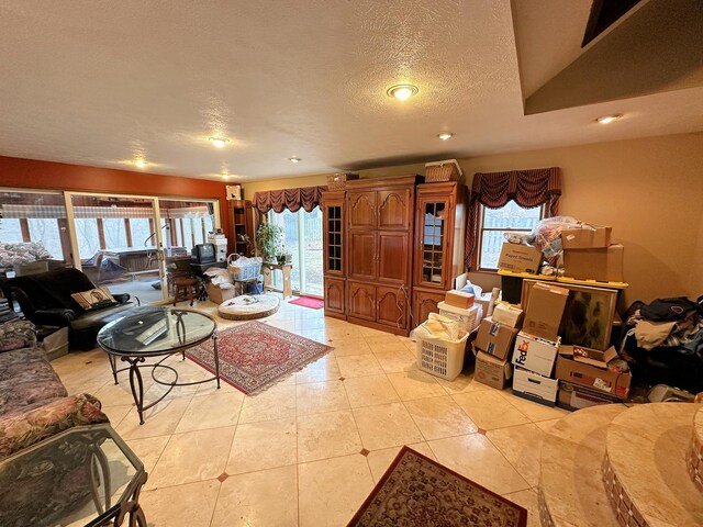 tiled living room featuring a textured ceiling and plenty of natural light