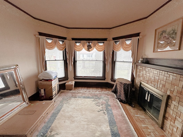 sitting room with hardwood / wood-style flooring and crown molding