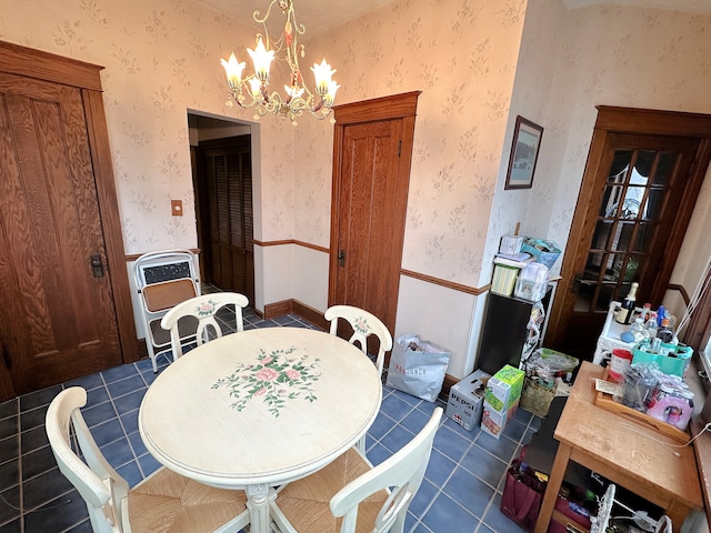 dining area featuring dark tile patterned flooring, heating unit, and a notable chandelier