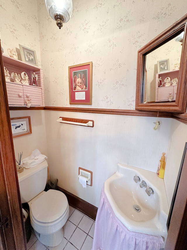 bathroom featuring tile patterned flooring, toilet, and sink