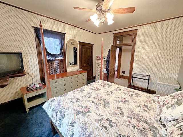 bedroom featuring ornamental molding, ceiling fan, and carpet flooring