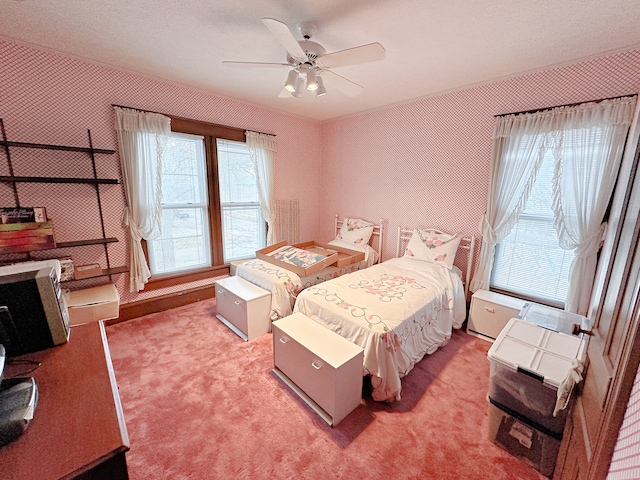 bedroom featuring carpet flooring, ceiling fan, and multiple windows