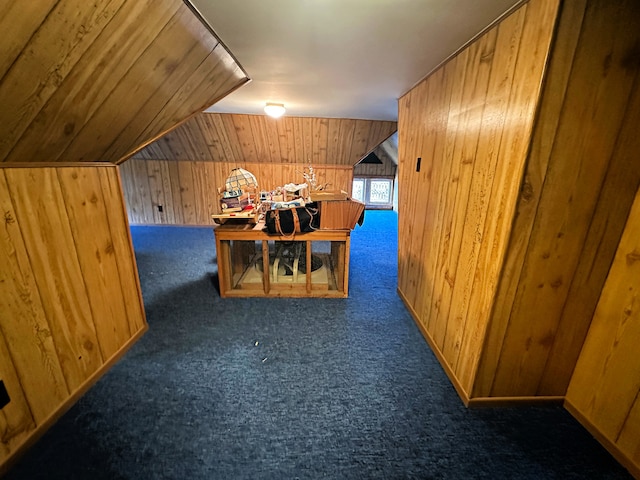 bonus room featuring lofted ceiling, wood walls, and carpet floors