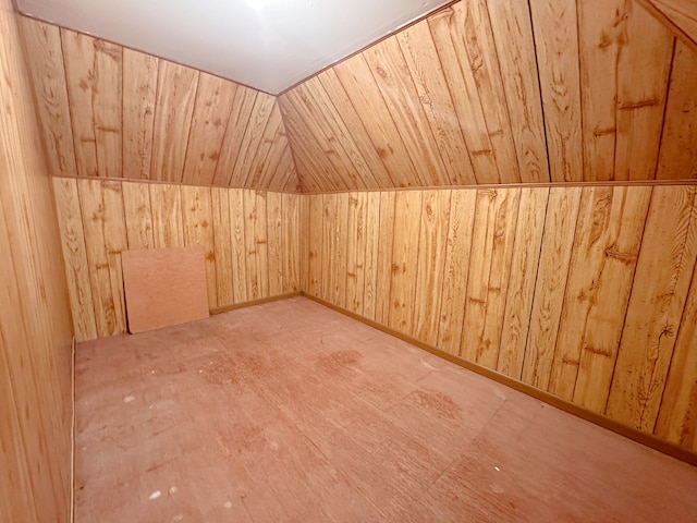 additional living space featuring lofted ceiling, wood walls, and wooden ceiling