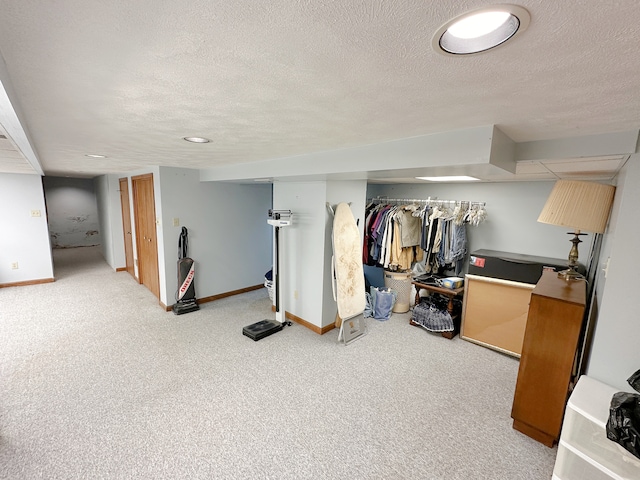 basement with a textured ceiling and carpet flooring