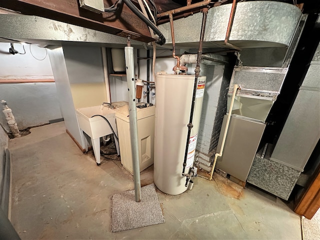 utility room featuring water heater, sink, and washer / clothes dryer