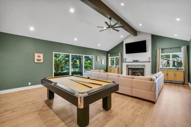 recreation room featuring a stone fireplace, light hardwood / wood-style floors, plenty of natural light, and pool table