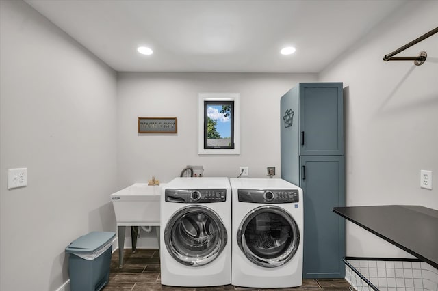 clothes washing area featuring dark wood-type flooring and washing machine and clothes dryer