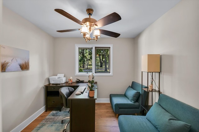 home office featuring light wood-type flooring and ceiling fan