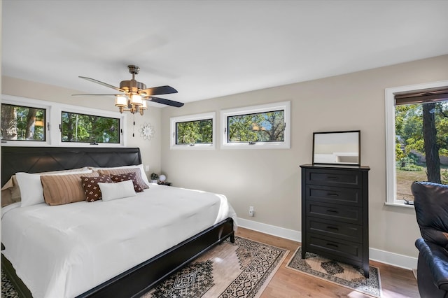 bedroom with ceiling fan and hardwood / wood-style flooring