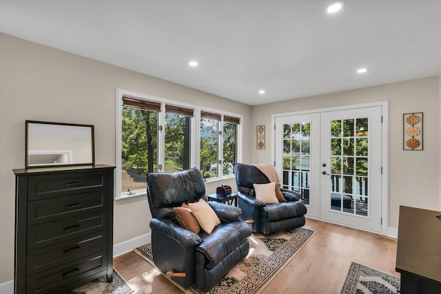 living room featuring light wood-type flooring and french doors