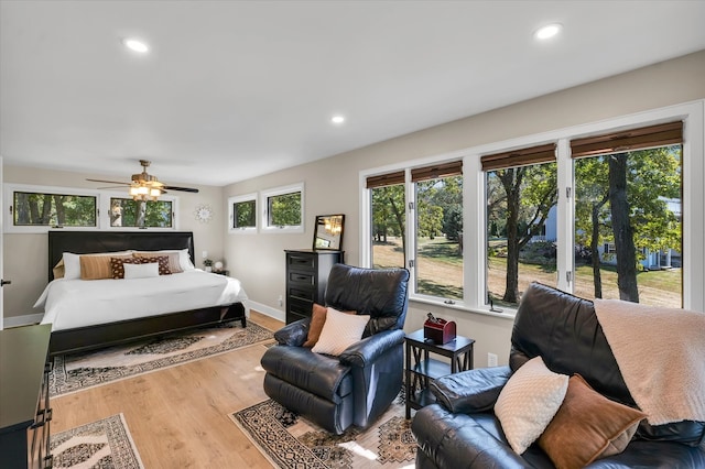 bedroom with hardwood / wood-style floors and ceiling fan