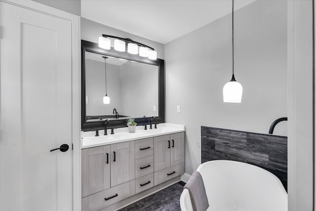 bathroom with vanity and a washtub