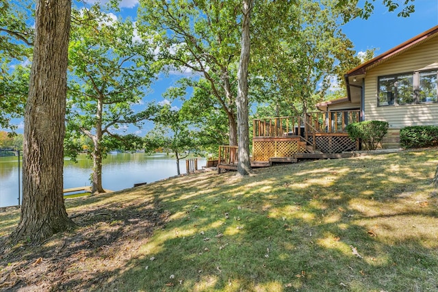 view of yard with a deck with water view