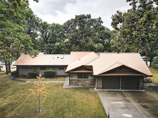 view of front of property with a front lawn and a garage