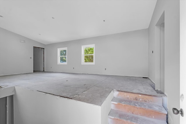 empty room featuring vaulted ceiling