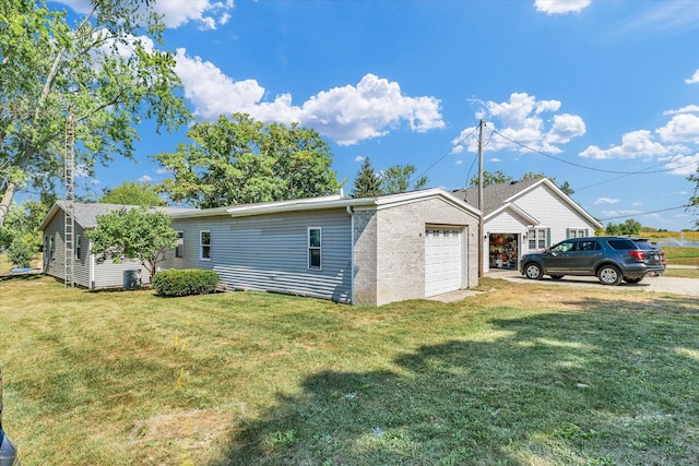 back of property featuring a lawn and a garage