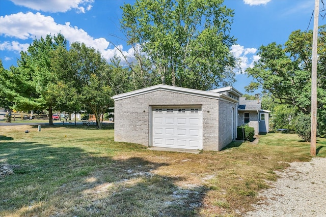 garage featuring a lawn