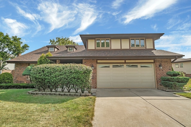 view of front of home featuring a garage and a front lawn