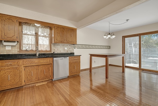 kitchen with light wood-type flooring, dishwasher, a chandelier, and sink