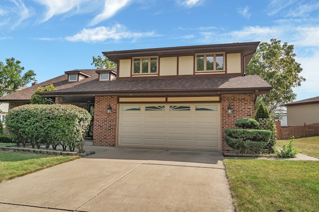 view of front of home with a garage and a front lawn