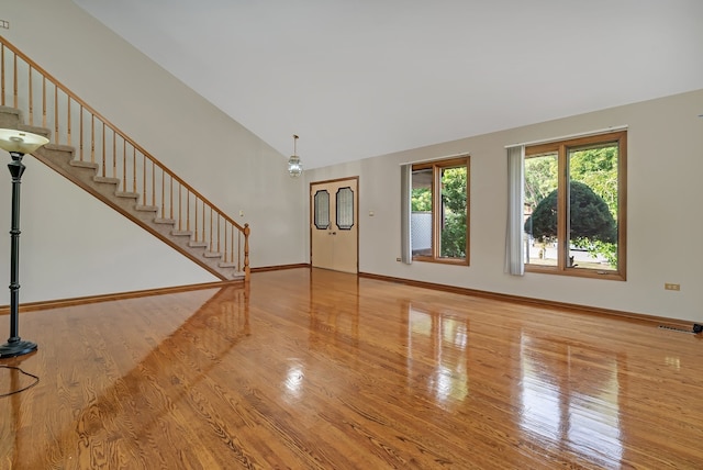 interior space featuring lofted ceiling and hardwood / wood-style flooring