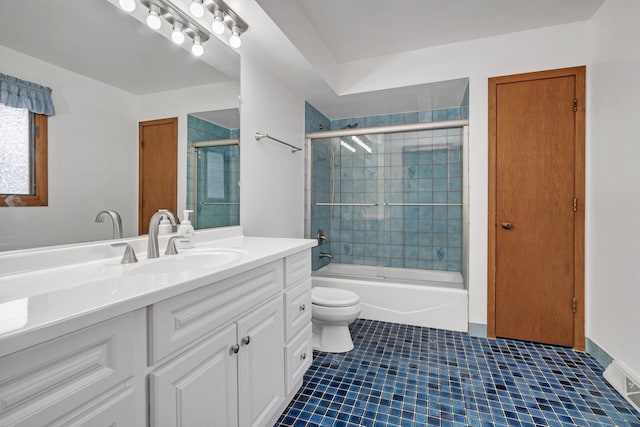 full bathroom featuring vanity, toilet, tile patterned floors, and enclosed tub / shower combo