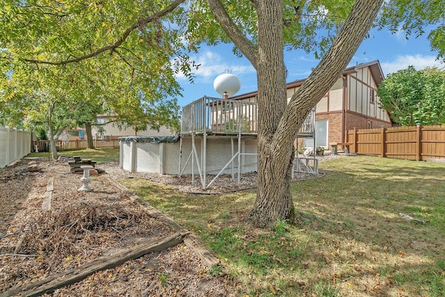 exterior space featuring a pool side deck and a lawn