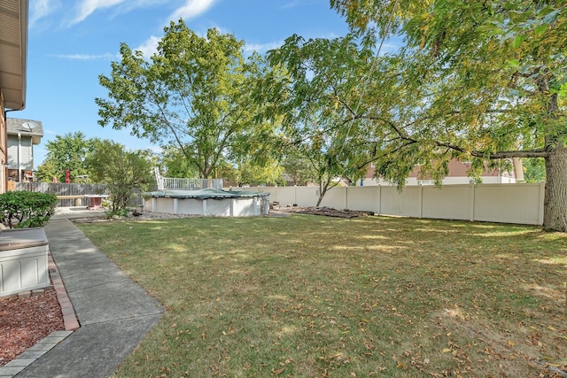 view of yard with a covered pool