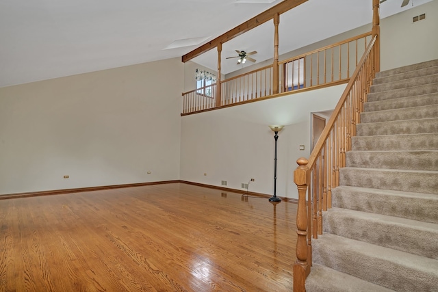 staircase featuring beamed ceiling, high vaulted ceiling, hardwood / wood-style floors, and ceiling fan