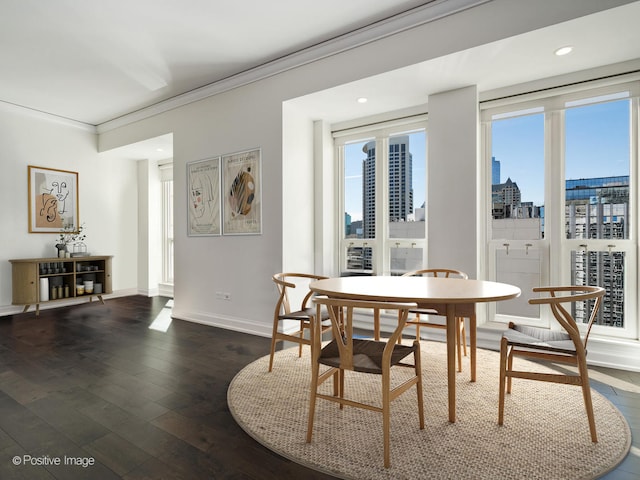 dining space featuring dark wood-type flooring, plenty of natural light, and ornamental molding