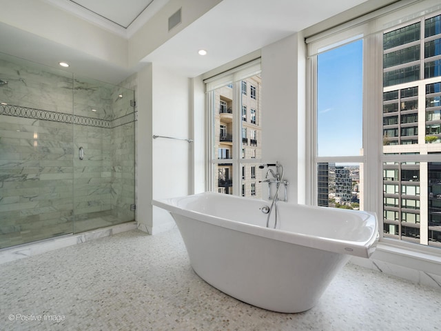 bathroom featuring shower with separate bathtub