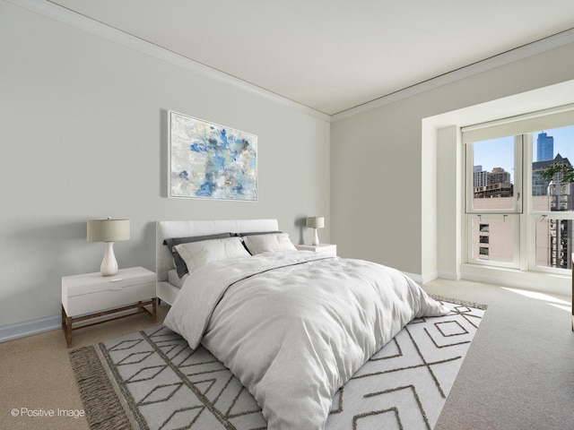 bedroom with carpet floors and crown molding