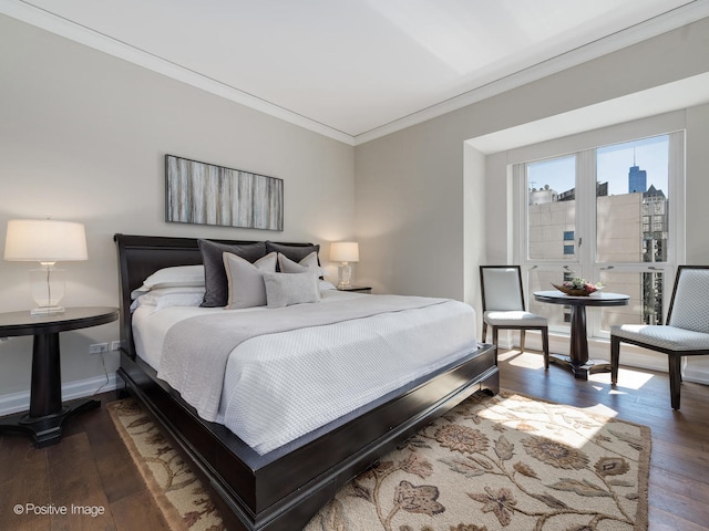 bedroom with crown molding and hardwood / wood-style floors