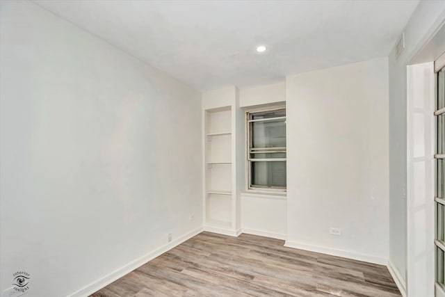 spare room with light hardwood / wood-style floors