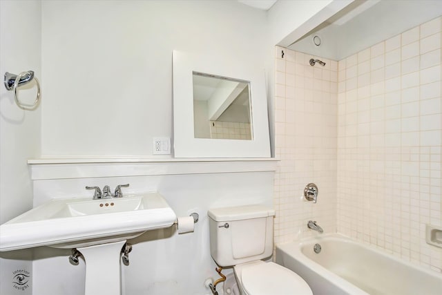 bathroom with tiled shower / bath combo and toilet