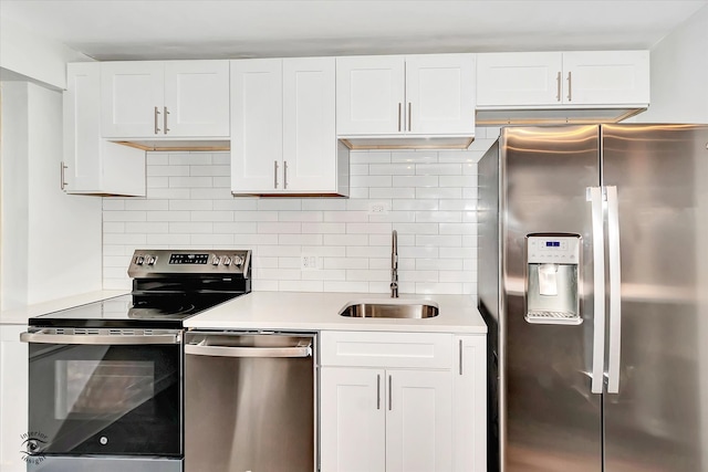 kitchen featuring decorative backsplash, white cabinetry, appliances with stainless steel finishes, and sink