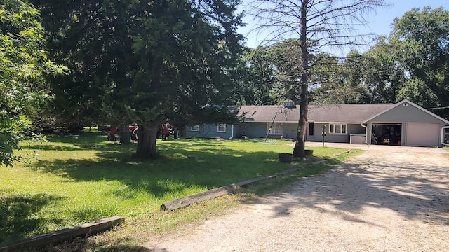 view of front of home with a front lawn and a garage