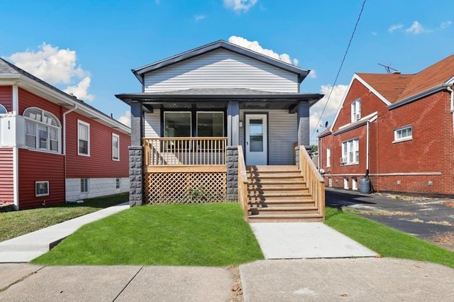 bungalow-style house with covered porch and a front lawn