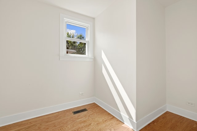 unfurnished room featuring hardwood / wood-style floors