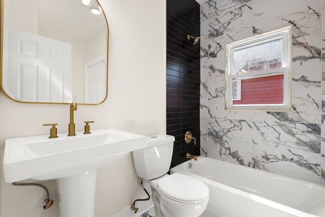 full bathroom featuring toilet, tiled shower / bath, and sink