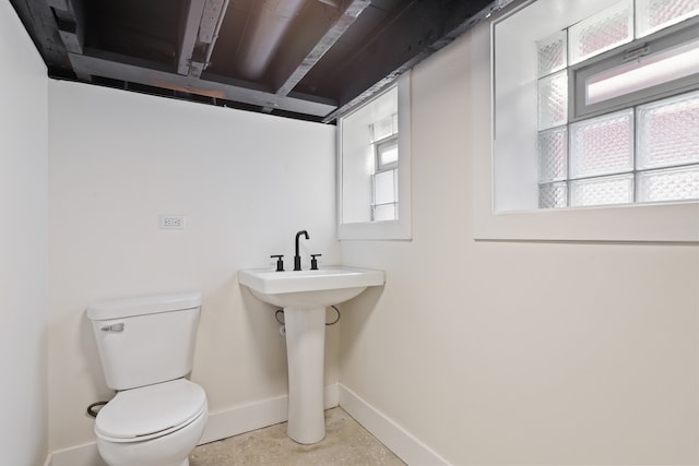 bathroom with toilet and a wealth of natural light