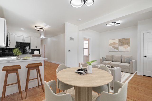 dining area with light hardwood / wood-style floors