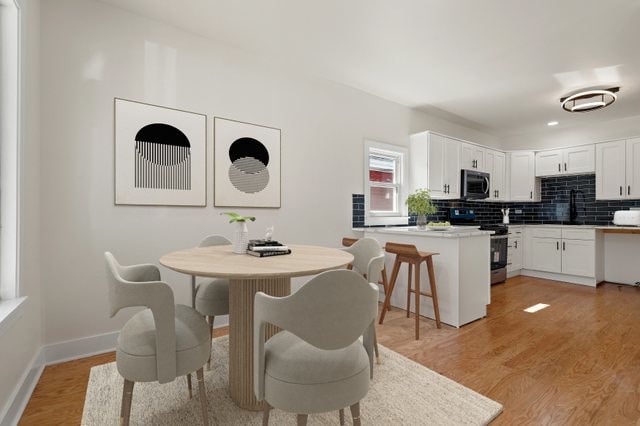 dining room with light hardwood / wood-style floors and sink