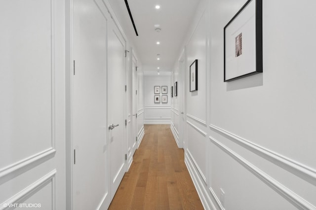 corridor with wood-type flooring