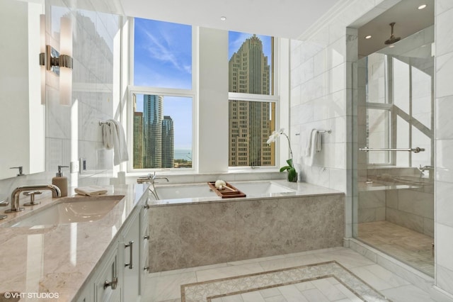 bathroom featuring separate shower and tub and vanity