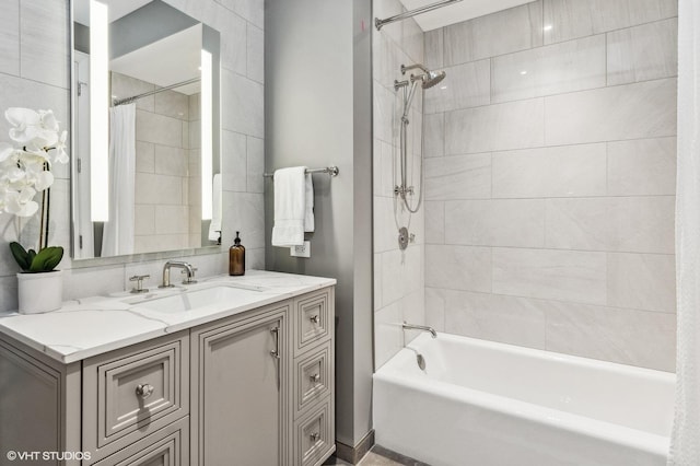 bathroom featuring shower / tub combo and vanity