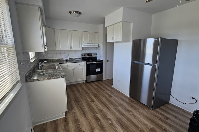 kitchen featuring sink, dark wood-type flooring, decorative backsplash, white cabinets, and appliances with stainless steel finishes