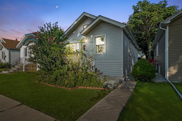 bungalow-style home with a yard