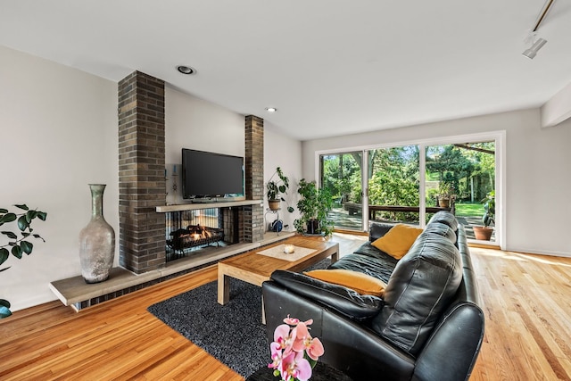 living room with wood-type flooring and a fireplace